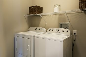 two washers and a dryer in a laundry room  at Watermark at Harvest Junction, Colorado, 80501